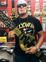 Hogan holding the WCW NWO Championship Title Belt Replica after signing it